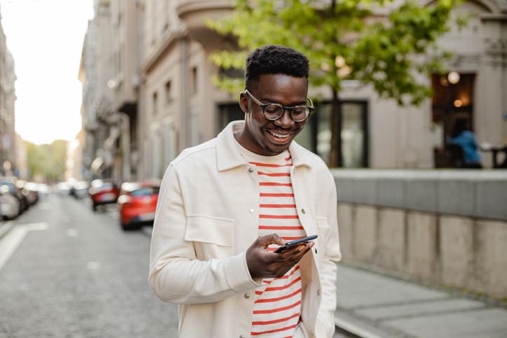 A young man uses Spark on a mobile to communicate with a financial service provider
