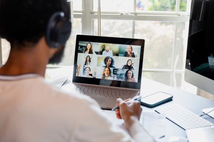 Employee taking part in a virtual event on his laptop